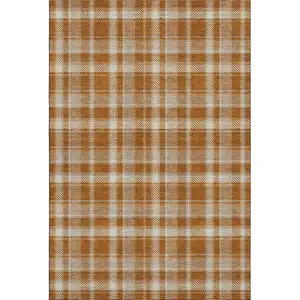 Photo of Rust And Ivory Plaid Washable Area Rug With UV Protection