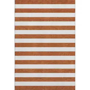 Photo of Rust And Ivory Striped Washable Area Rug With UV Protection