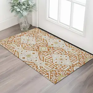 Photo of Rust Beige And Gold Floral Washable Area Rug With UV Protection