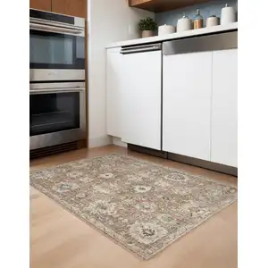 Photo of Rust Green And Black Floral Distressed Area Rug