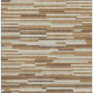 Photo of Rust Ivory And Beige Striped Washable Area Rug With UV Protection