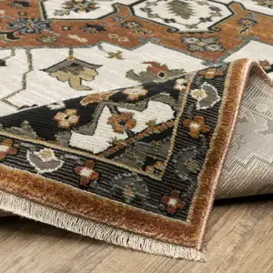 Photo of Rust Ivory And Black Medallion Area Rug With Fringe