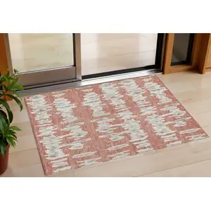 Photo of Salmon And Gray Striped Washable Indoor Outdoor Area Rug
