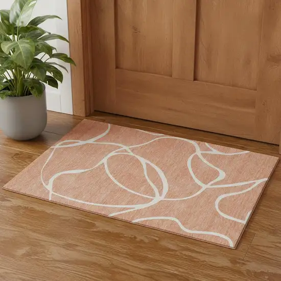 Salmon And Ivory Abstract Washable Area Rug With UV Protection Photo 1