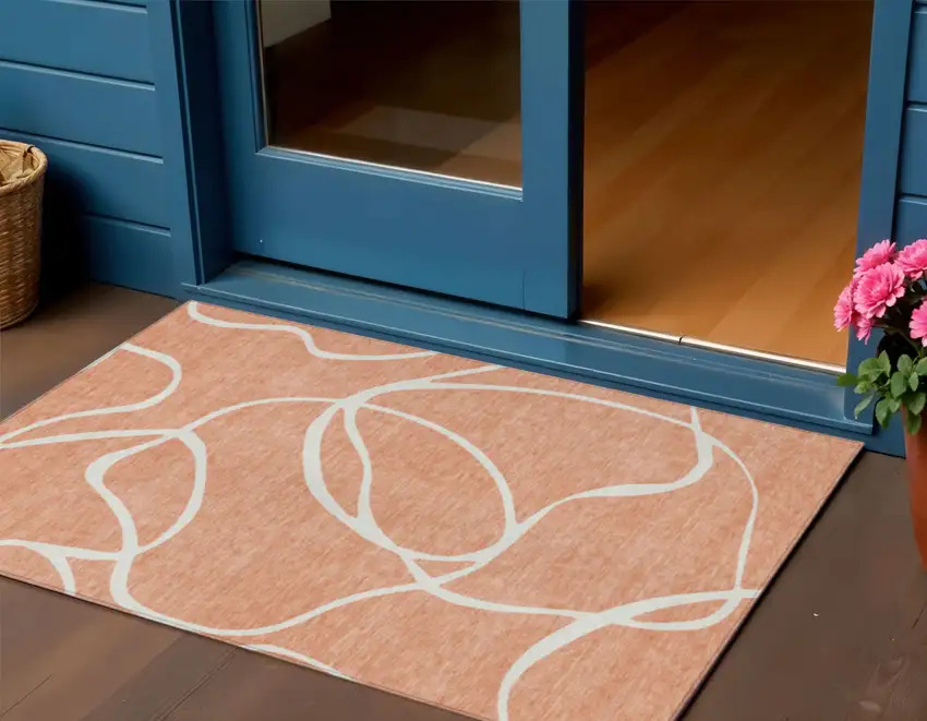 Salmon And Ivory Abstract Washable Indoor Outdoor Area Rug Photo 1