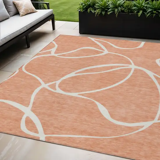 Salmon And Ivory Abstract Washable Indoor Outdoor Area Rug Photo 1