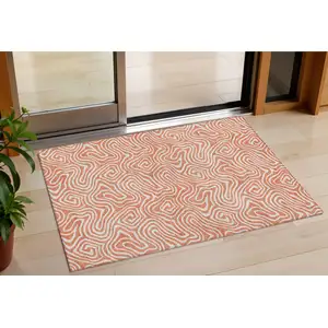 Photo of Salmon And Ivory Abstract Washable Indoor Outdoor Area Rug