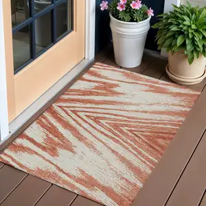 Photo of Salmon And Ivory Abstract Washable Indoor Outdoor Area Rug