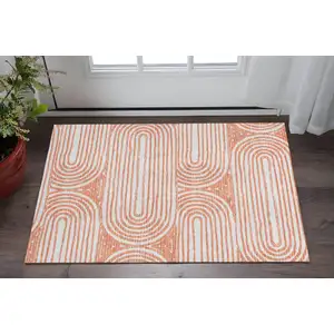 Photo of Salmon And Ivory Geometric Washable Area Rug With UV Protection