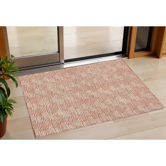 Salmon And Ivory Geometric Washable Indoor Outdoor Area Rug Photo 1