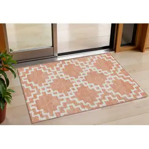 Photo of Salmon And Ivory Geometric Washable Indoor Outdoor Area Rug