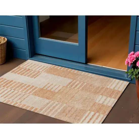 Salmon Peach And Ivory Striped Washable Indoor Outdoor Area Rug Photo 1
