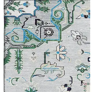 Photo of Silver Blue And Ivory Oriental Washable Area Rug With UV Protection