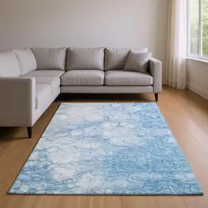 Photo of Sky Blue And Ivory Abstract Washable Area Rug With UV Protection