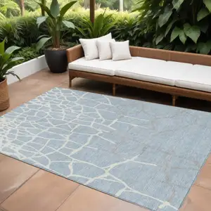 Photo of Sky Blue And Ivory Abstract Washable Indoor Outdoor Area Rug