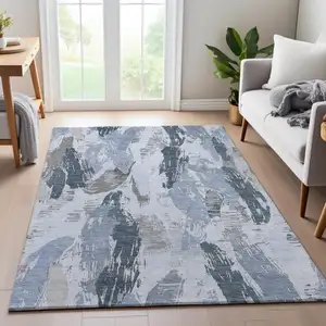 Photo of Sky Blue Gray And Ivory Abstract Washable Area Rug With UV Protection