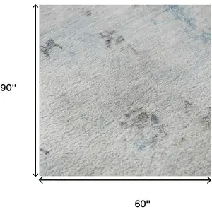 Photo of Sky Blue Ivory And Gray Abstract Washable Area Rug With UV Protection