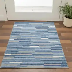 Photo of Sky Blue Ivory And Gray Striped Washable Area Rug With UV Protection
