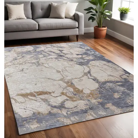 Tan Blue And Beige Abstract Distressed Area Rug Photo 1