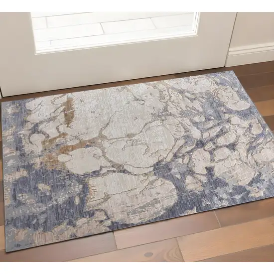 Tan Blue And Beige Abstract Distressed Area Rug Photo 1