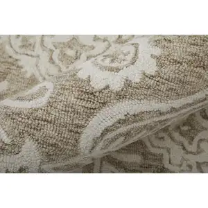 Photo of Tan And Ivory Wool Paisley Tufted Handmade Stain Resistant Area Rug