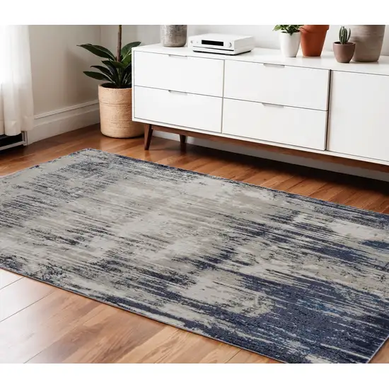 Tan Blue And Ivory Abstract Power Loom Distressed Area Rug Photo 1