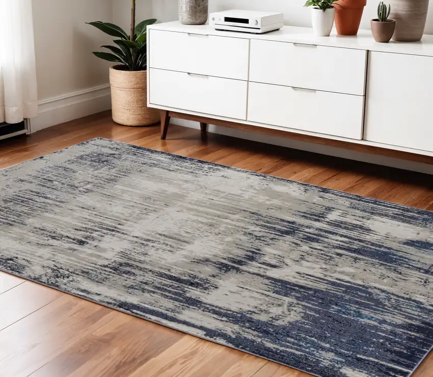 Tan Blue And Ivory Abstract Power Loom Distressed Area Rug Photo 1