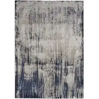 Photo of Tan Blue And Ivory Abstract Power Loom Distressed Area Rug