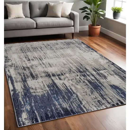 Tan Blue And Ivory Abstract Power Loom Distressed Area Rug Photo 1