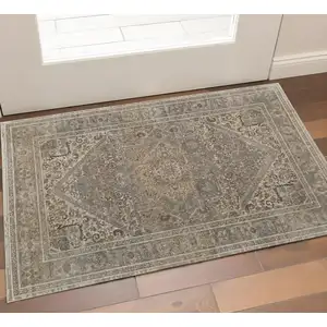 Photo of Tan Brown And Ivory Floral Power Loom Distressed Area Rug