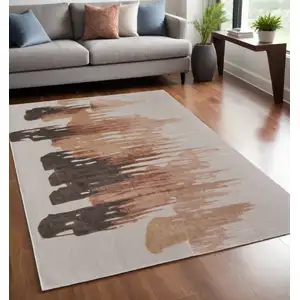 Photo of Tan Brown and Orange Abstract Hand Tufted Area Rug