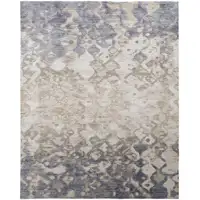 Photo of Tan Ivory And Blue Abstract Power Loom Distressed Area Rug