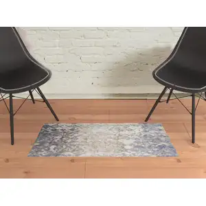 Photo of Tan Ivory And Blue Abstract Power Loom Distressed Area Rug