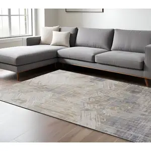 Photo of Tan Ivory And Gray Abstract Power Loom Distressed Area Rug