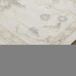 Photo of Tan Ivory And Orange Floral Hand Knotted Stain Resistant Area Rug