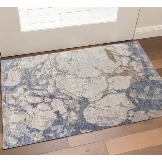 Tan Blue And Beige Abstract Distressed Area Rug Photo 1