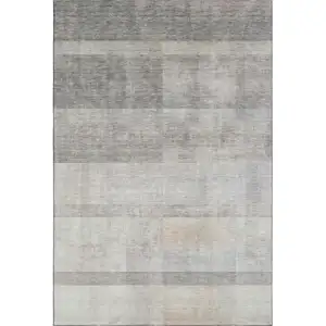Photo of Taupe And Ivory Abstract Washable Area Rug With UV Protection