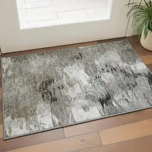Photo of Taupe And Ivory Abstract Washable Area Rug With UV Protection