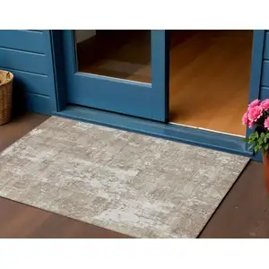 Photo of Taupe And Ivory Abstract Washable Indoor Outdoor Area Rug