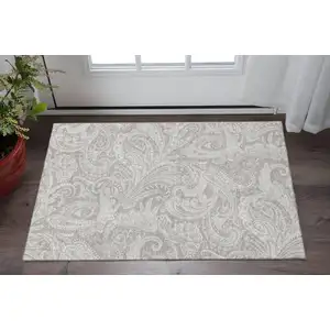 Photo of Taupe And Ivory Paisley Washable Area Rug With UV Protection