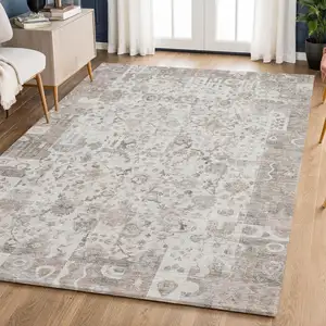 Photo of Taupe And Ivory Patchwork Washable Area Rug With UV Protection