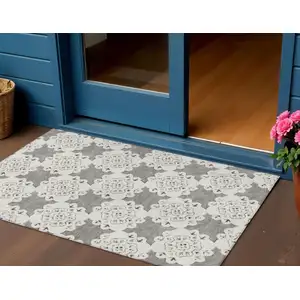 Photo of Taupe And Ivory Quatrefoil Washable Indoor Outdoor Area Rug