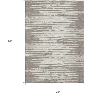 Photo of Taupe And Ivory Striped Washable Indoor Outdoor Area Rug