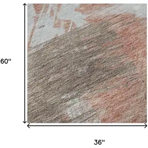 Photo of Taupe Blue And Ivory Abstract Washable Area Rug With UV Protection