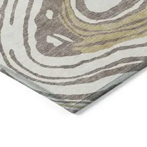 Photo of Taupe Brown And Beige Abstract Washable Indoor Outdoor Area Rug
