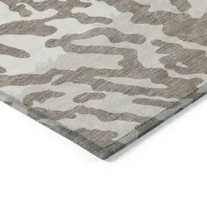 Photo of Taupe Brown And Ivory Animal Print Washable Indoor Outdoor Area Rug