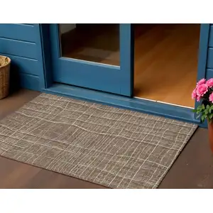 Photo of Taupe Brown And Ivory Striped Washable Indoor Outdoor Area Rug