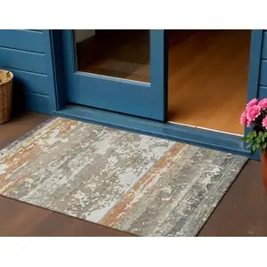 Photo of Taupe Copper And Ivory Striped Washable Indoor Outdoor Area Rug