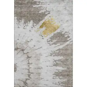 Photo of Taupe Gold And Ivory Abstract Washable Area Rug With UV Protection