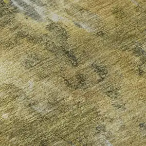 Photo of Taupe Gold And Ivory Abstract Washable Area Rug With UV Protection